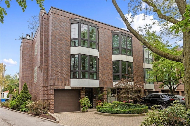 1162 W Farwell Ave, Chicago, IL 60626 - view of property featuring an attached garage and decorative driveway