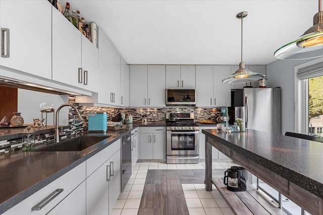 1162 W Farwell Ave, Chicago, IL 60626 - kitchen featuring appliances with stainless steel finishes, a sink, decorative backsplash, dark countertops, and light tile patterned floors