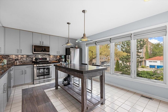 1162 W Farwell Ave, Chicago, IL 60626 - kitchen with stainless steel appliances, dark countertops, tasteful backsplash, and plenty of natural light