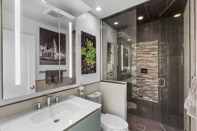 1162 W Farwell Ave, Chicago, IL 60626 - bathroom with tile walls, toilet, a stall shower, vanity, and recessed lighting