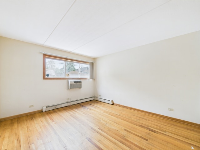 914 N Austin Blvd Unit A5, Oak Park, IL 60302 - spare room with a baseboard radiator, wood finished floors, a wall mounted air conditioner, and baseboards