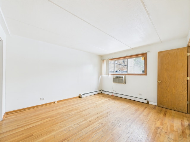 914 N Austin Blvd Unit A5, Oak Park, IL 60302 - unfurnished room with hardwood / wood-style floors, an AC wall unit, baseboard heating, and baseboards