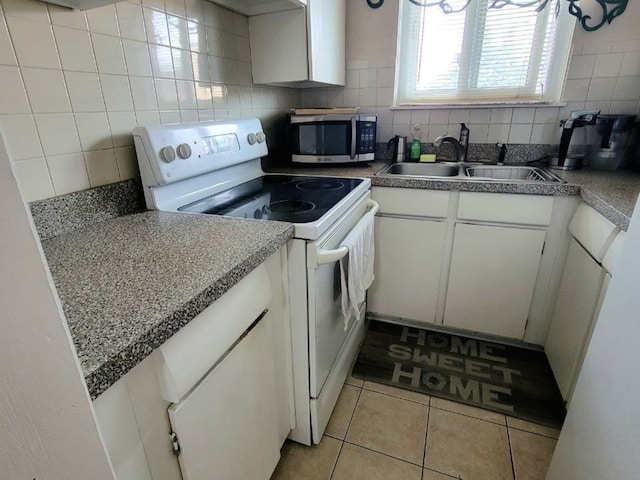 1509 Brown St Unit 11E, Des Plaines, IL 60016 - kitchen with white electric range oven, stainless steel microwave, a sink, white cabinets, and light tile patterned floors