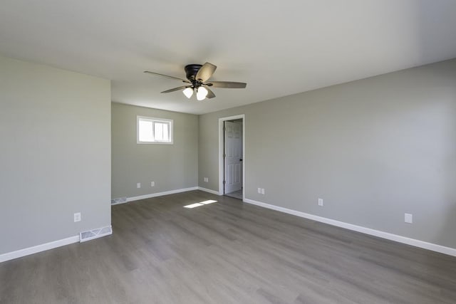 6008 240th Ave, Paddock Lake, WI 53168 - unfurnished room featuring a ceiling fan, baseboards, and dark wood-style flooring