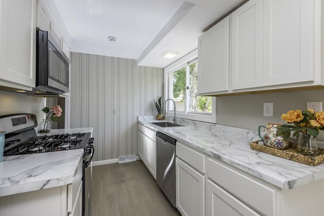 6008 240th Ave, Paddock Lake, WI 53168 - kitchen with appliances with stainless steel finishes, a sink, wood finished floors, and white cabinetry