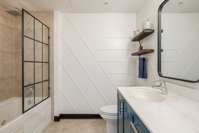 bathroom featuring toilet, vanity, tile patterned flooring, and bathing tub / shower combination