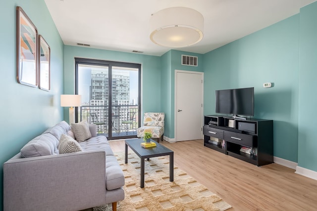 living area with wood finished floors and baseboards