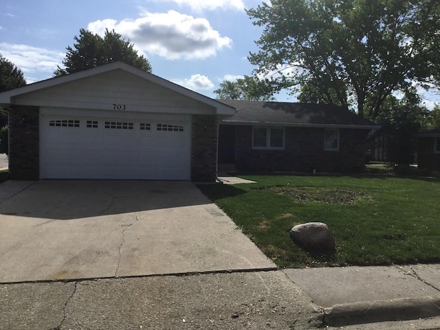 ranch-style home featuring a front lawn, brick siding, concrete driveway, and an attached garage