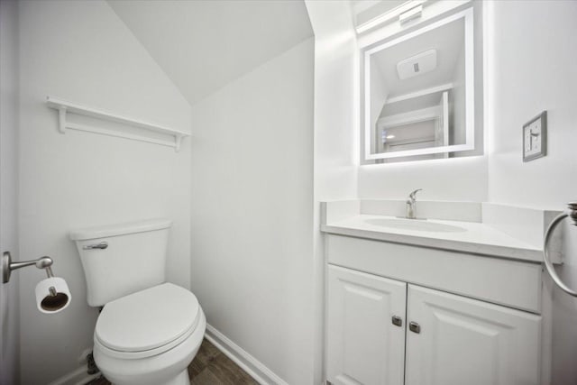 1242 N Knollwood Dr Unit 1242, Palatine, IL 60067 - bathroom with vanity, toilet, lofted ceiling, baseboards, and wood finished floors