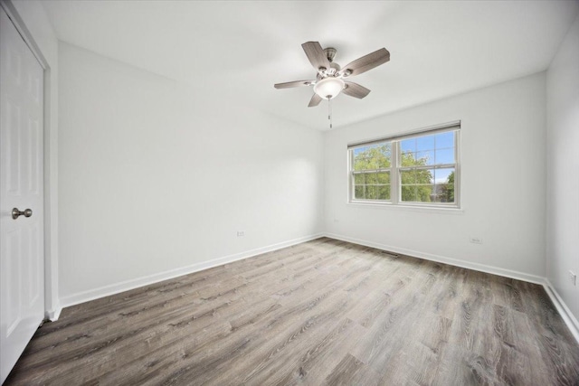 1242 N Knollwood Dr Unit 1242, Palatine, IL 60067 - unfurnished bedroom featuring wood finished floors, baseboards, and a ceiling fan