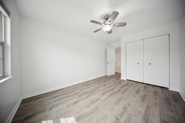 1242 N Knollwood Dr Unit 1242, Palatine, IL 60067 - unfurnished bedroom with wood finished floors, a closet, baseboards, and a ceiling fan