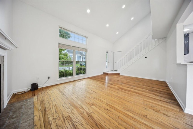 1242 N Knollwood Dr Unit 1242, Palatine, IL 60067 - unfurnished living room featuring stairs, hardwood / wood-style flooring, high vaulted ceiling, recessed lighting, and baseboards