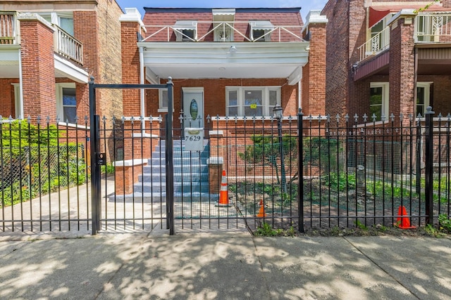 7629 S Green St, Chicago, IL 60620 - view of front of property featuring a fenced front yard, brick siding, and mansard roof