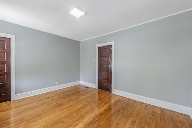 7629 S Green St, Chicago, IL 60620 - empty room with baseboards and wood finished floors