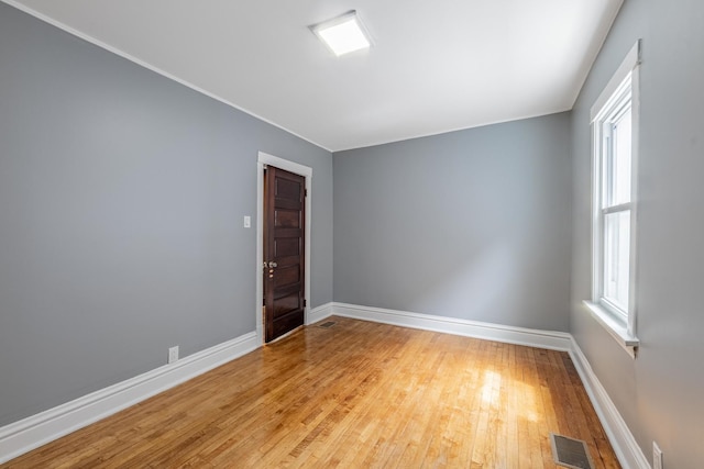 7629 S Green St, Chicago, IL 60620 - spare room featuring light wood-style flooring, baseboards, and ornamental molding