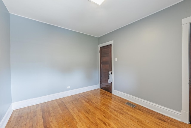 7629 S Green St, Chicago, IL 60620 - unfurnished room with baseboards, light wood finished floors, and crown molding