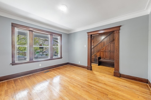 7629 S Green St, Chicago, IL 60620 - spare room featuring baseboards, light wood-style flooring, ornamental molding, and stairs
