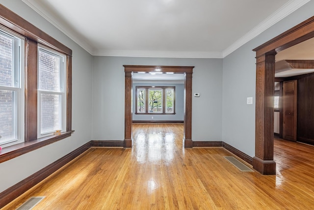 7629 S Green St, Chicago, IL 60620 - spare room featuring light wood-style floors, baseboards, ornamental molding, and ornate columns