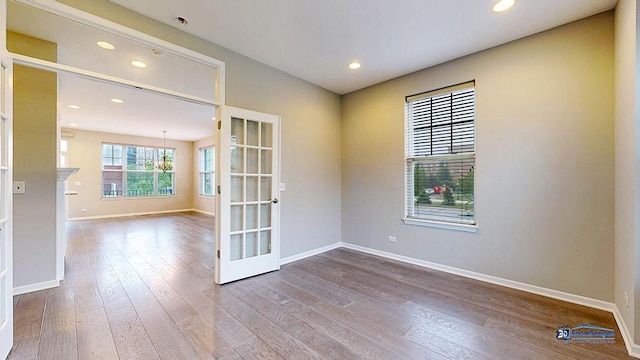 1255 Danforth Ct, Vernon Hills, IL 60061 - spare room featuring wood-type flooring, baseboards, french doors, recessed lighting, and a chandelier