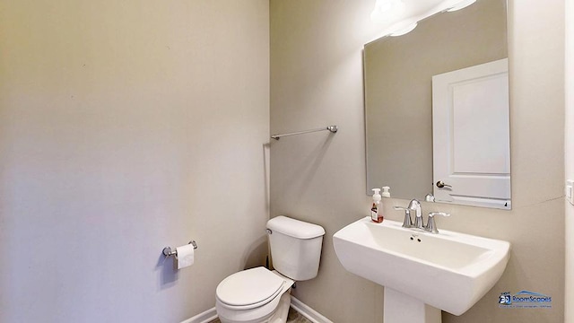 1255 Danforth Ct, Vernon Hills, IL 60061 - half bathroom featuring toilet, baseboards, and a sink