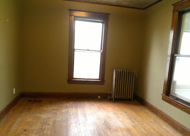 201 E N St, Ridge Farm, IL 61870 - empty room featuring radiator, light wood finished floors, and baseboards