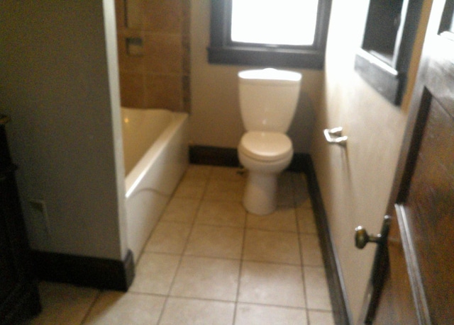 201 E N St, Ridge Farm, IL 61870 - full bath featuring toilet, tile patterned floors, a shower, and a tub to relax in
