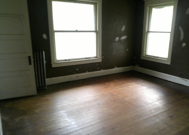 201 E N St, Ridge Farm, IL 61870 - spare room with radiator heating unit and wood finished floors