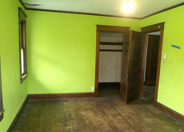201 E N St, Ridge Farm, IL 61870 - unfurnished bedroom with hardwood / wood-style floors, baseboards, ornamental molding, and a closet