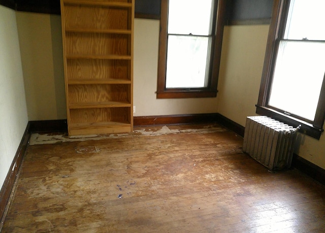 201 E N St, Ridge Farm, IL 61870 - unfurnished room featuring radiator heating unit, hardwood / wood-style flooring, and baseboards