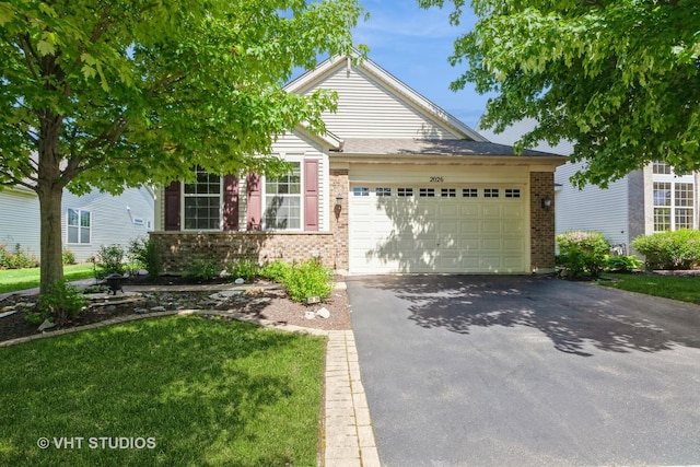 2026 Highbury Ln, Aurora, IL 60502 - view of front of home featuring brick siding, asphalt driveway, and an attached garage