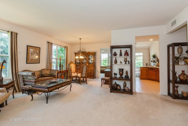 2026 Highbury Ln, Aurora, IL 60502 - living area featuring light colored carpet and a chandelier