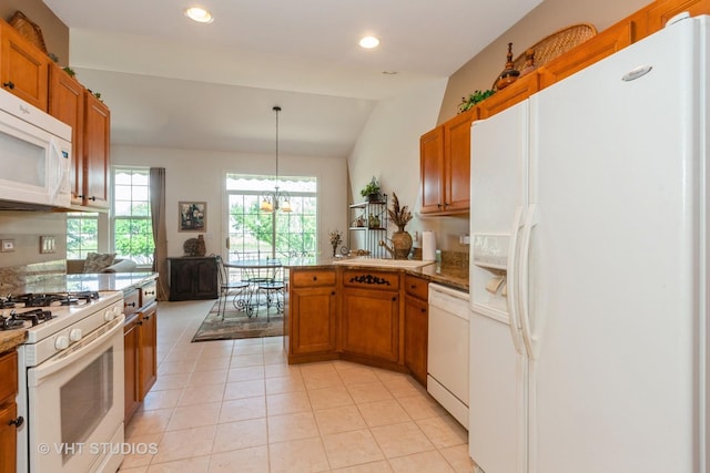 2026 Highbury Ln, Aurora, IL 60502 - kitchen featuring white appliances, brown cabinets, a peninsula, light tile patterned floors, and vaulted ceiling