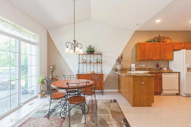 2026 Highbury Ln, Aurora, IL 60502 - kitchen with white appliances, brown cabinets, a peninsula, healthy amount of natural light, and lofted ceiling