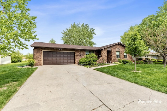 857 Edwin Dr, Bourbonnais, IL 60914 - ranch-style house featuring brick siding, an attached garage, driveway, and a front lawn