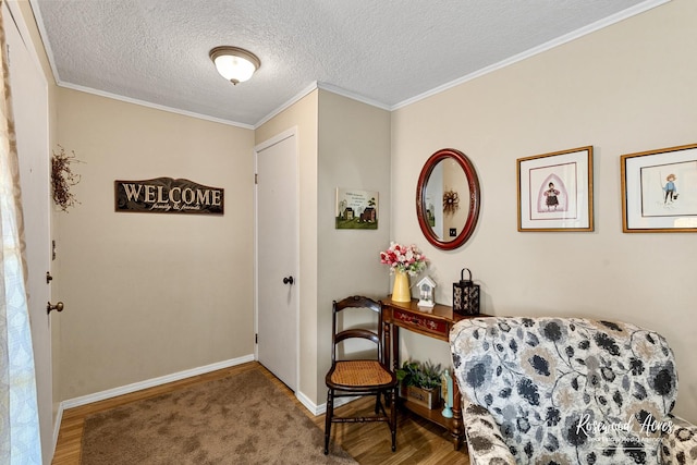 857 Edwin Dr, Bourbonnais, IL 60914 - sitting room featuring wood finished floors, a textured ceiling, baseboards, and crown molding