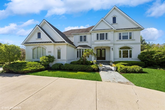 6916 Fieldstone Dr, Burr Ridge, IL 60527 - view of front facade featuring french doors, stucco siding, a standing seam roof, and a front yard