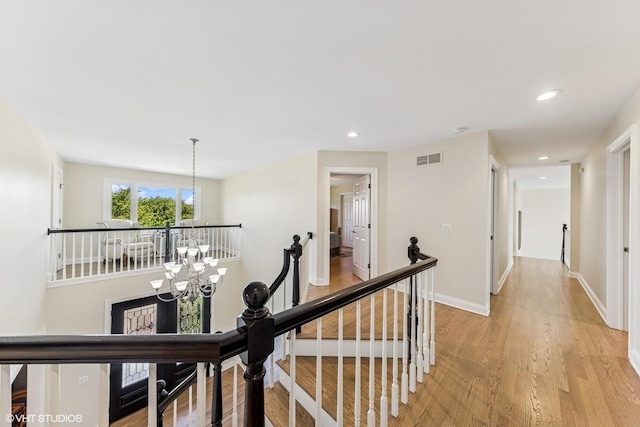 6916 Fieldstone Dr, Burr Ridge, IL 60527 - hall with an upstairs landing, a chandelier, light wood-style flooring, recessed lighting, and baseboards