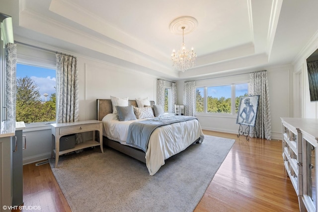 6916 Fieldstone Dr, Burr Ridge, IL 60527 - bedroom with a raised ceiling, a chandelier, light wood-style flooring, crown molding, and baseboards