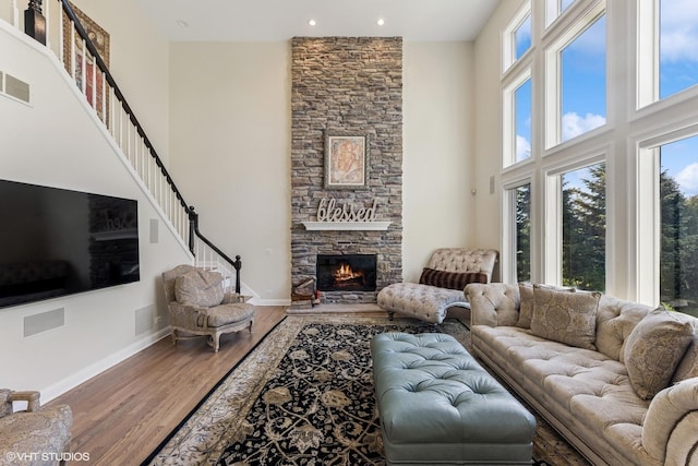 6916 Fieldstone Dr, Burr Ridge, IL 60527 - living area with a high ceiling, a fireplace, wood finished floors, recessed lighting, and baseboards