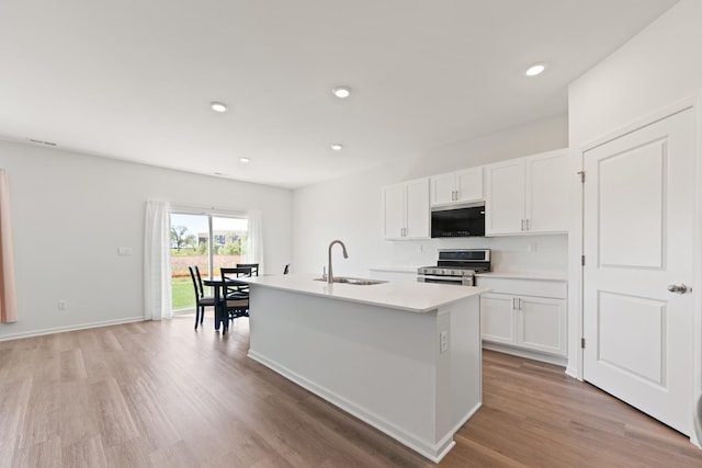 1391 Aspen Ln, Pingree Grove, IL 60140 - kitchen with electric range, a sink, light wood finished floors, a center island with sink, and recessed lighting