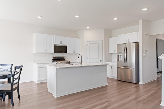 1391 Aspen Ln, Pingree Grove, IL 60140 - kitchen with stainless steel appliances, light countertops, white cabinets, light wood finished floors, and recessed lighting
