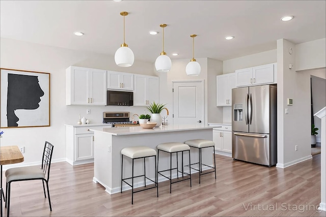 1391 Aspen Ln, Pingree Grove, IL 60140 - kitchen featuring stainless steel fridge, range, light countertops, a breakfast bar area, and white cabinets