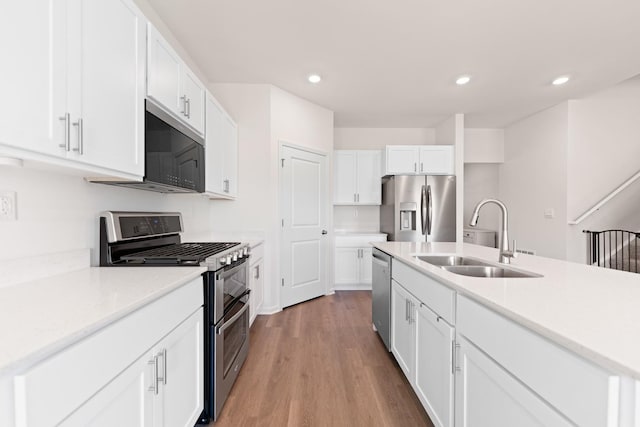 1391 Aspen Ln, Pingree Grove, IL 60140 - kitchen featuring appliances with stainless steel finishes, wood finished floors, white cabinetry, recessed lighting, and light countertops