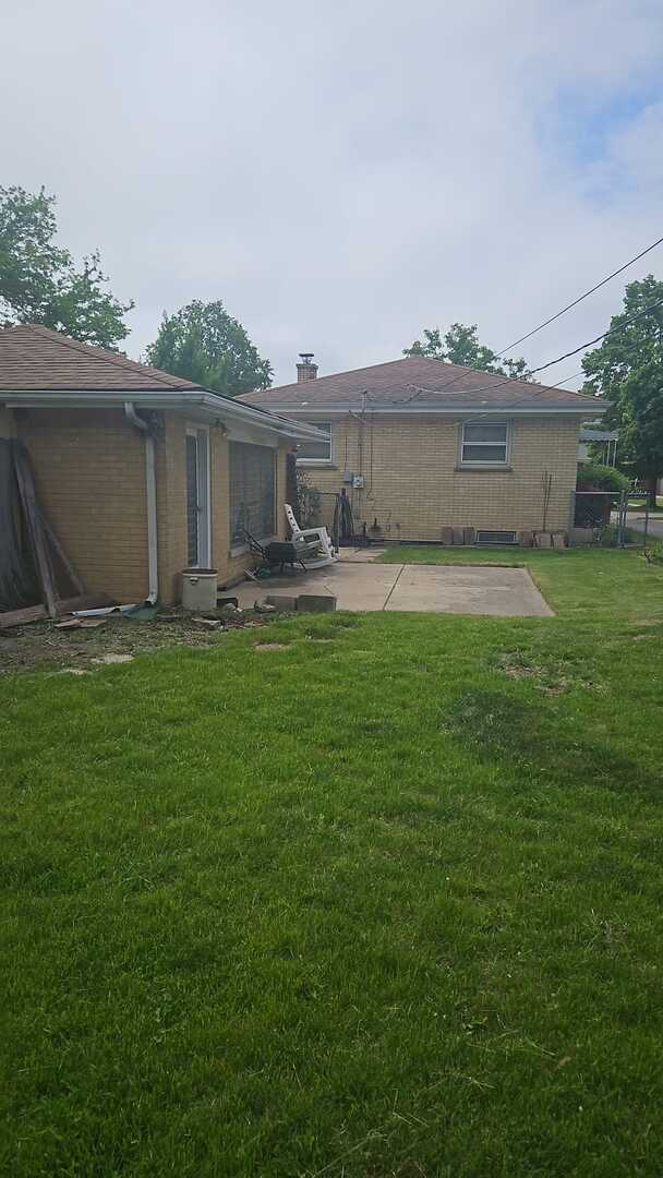 6140 Elm St, Morton Grove, IL 60053 - rear view of property with a patio area, brick siding, a yard, and a chimney