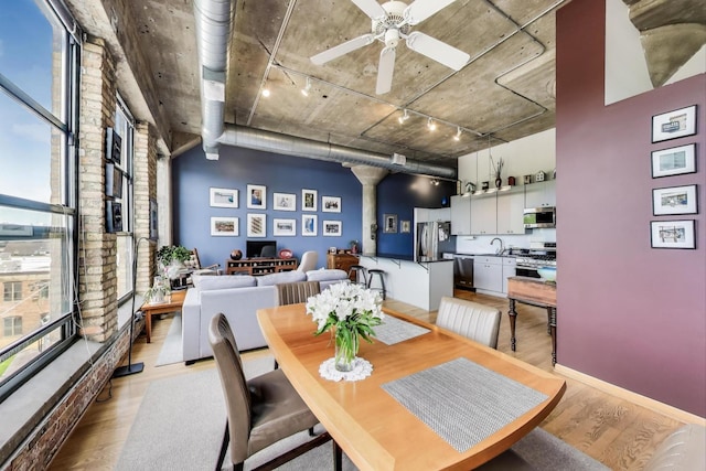 1800 W Roscoe St Unit 432, Chicago, IL 60657 - dining space featuring track lighting, light wood-style flooring, ornate columns, and a ceiling fan