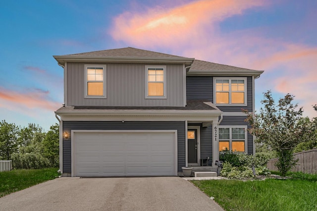 view of front of house with asphalt driveway, fence, an attached garage, and a shingled roof