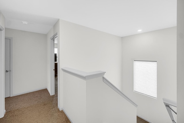 corridor with an upstairs landing, carpet floors, healthy amount of natural light, and recessed lighting