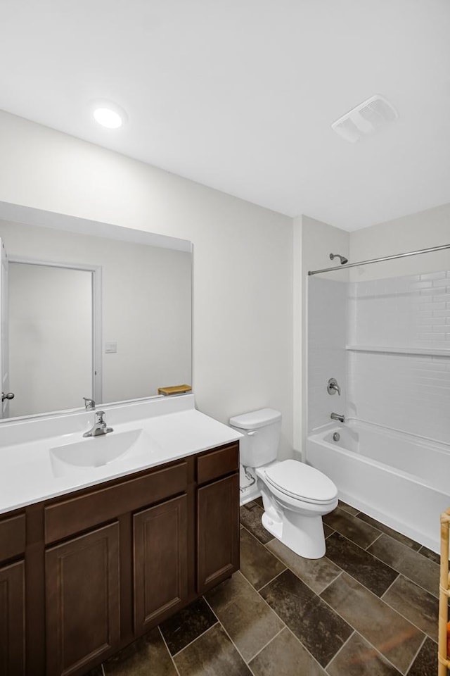 full bath featuring toilet, vanity,  shower combination, and stone finish flooring