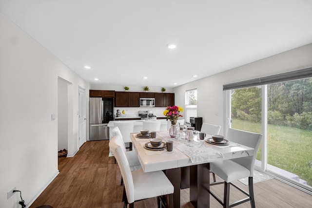 dining room with wood finished floors and recessed lighting