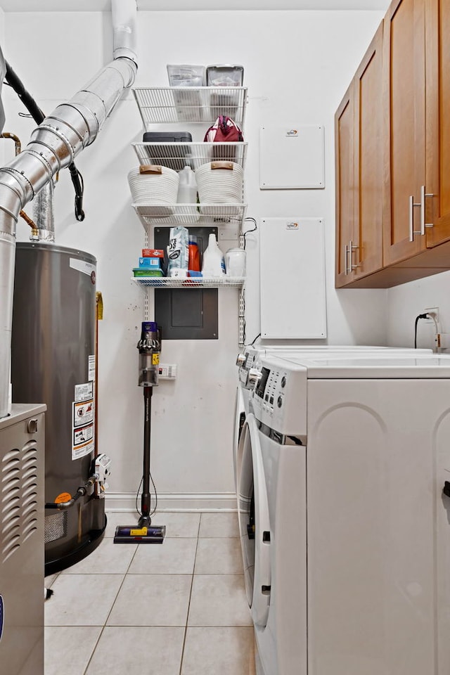 1359 W Fullerton Ave Unit 2E, Chicago, IL 60614 - laundry area with cabinet space, light tile patterned flooring, independent washer and dryer, water heater, and baseboards